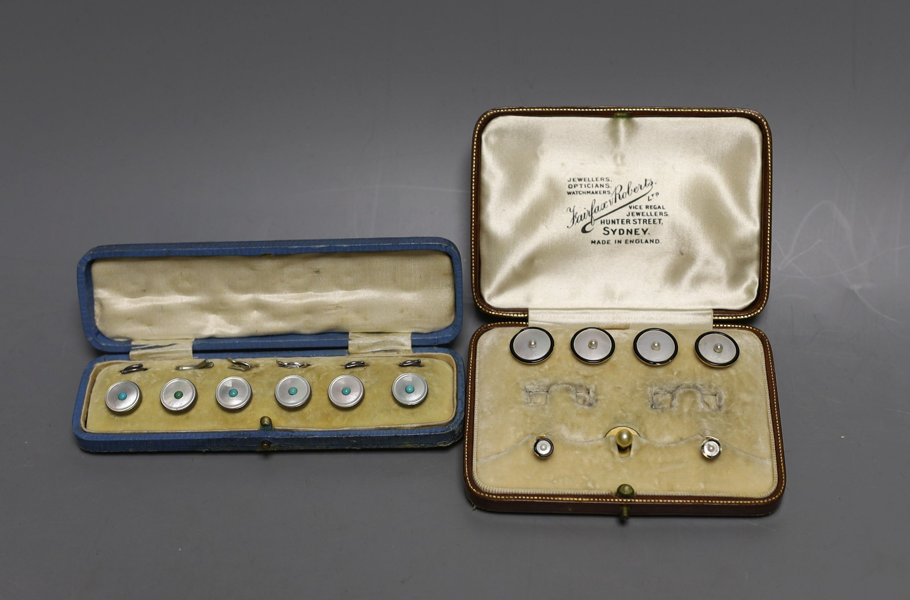 A set of four 18ct, mother of pearl, enamel and seed pearl set buttons, gross 7.2 grams, two similar 15ct studs, gross 2.3 grams and one other cased set of white metal dress studs.